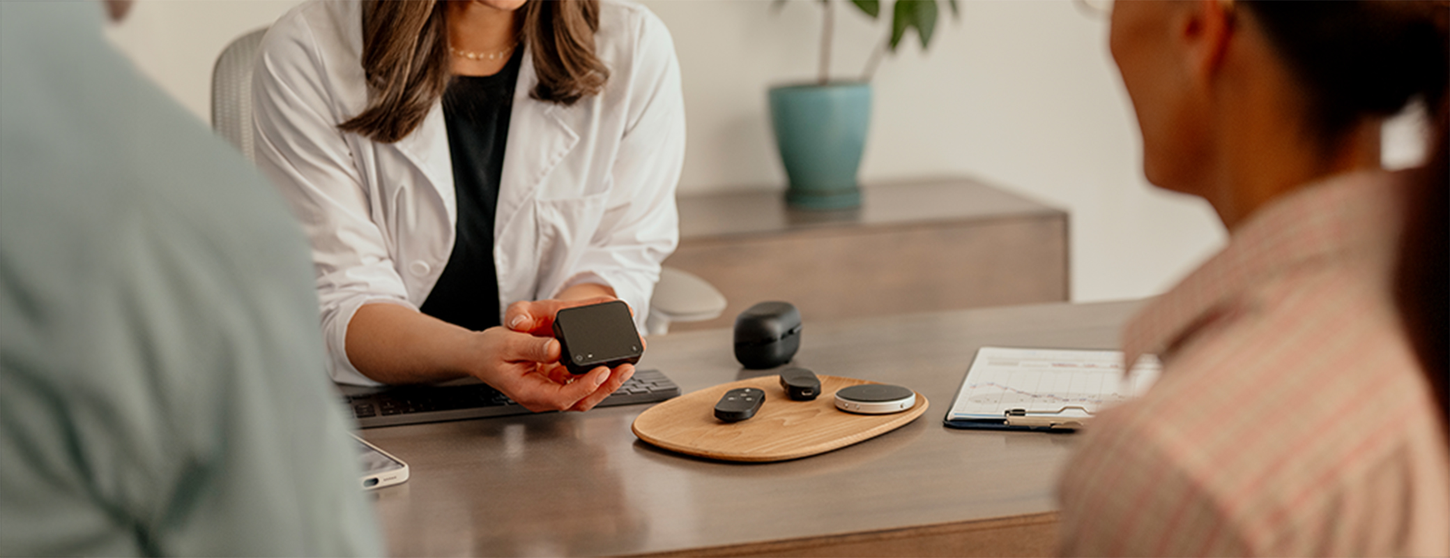 Image of couple being shown hearing technology by their hearing care professional